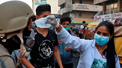 A protester receives first aid during the clashes between Iraqi security forces and anti-government demonstrators, in downtown Baghdad. AP Photo