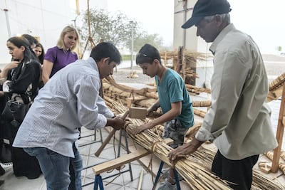 Boat builders Sajid Valappil and Abdul Salam show a visitor the techniques used to manufacture a Bronze Age Boat. Antonie Robertson,
