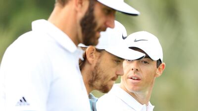 From left: Dustin Johnson of the United States, Tommy Fleetwood of England and Rory McIlroy of Northern Ireland walk on the eighth hole during round one of the Abu Dhabi HSBC Championship at Abu Dhabi Golf Club. Andrew Redington / Getty Images