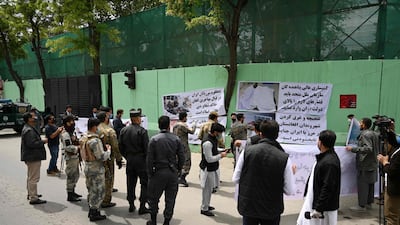 Civil society activists hold banners and shout slogans against the Iranian government during a protest in front of the Iranian embassy in Kabul on May 11, 2020. AFP