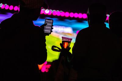 Football fans enjoy a beverage at the Fifa Fan Festival at Al Bidda park in Doha. AFP