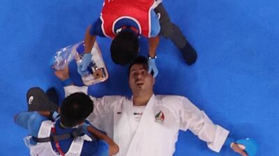 Sajad Ganjzadeh of Iran receives medical attention during his match against Tareg Hamedi of Saudi Arabia.