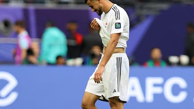 Iraq's Ayman Hussein reacts as he leaves the pitch after being sent off. Reuters