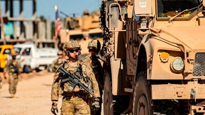 A US soldier stands by a US military armoured vehicle in the town of Tal Tamr along the M4 highway in the northeastern Syrian Hasakeh province, near the border with Turkey. AFP