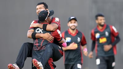 Zohaib Khan celebrating with Dwayne Bravo ( back ) of Lahore Qalandars after taking the wicket of JM Vince of Karachi Kings in the Pakistan Super League T20 match at Sharjah Cricket Stadium in Sharjah. ( Pawan Singh / The National )