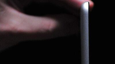 An Apple employee shows off the new iPad Air at a satellite launch event in central London. Carl Court / AFP