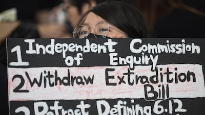 An anti-extradition bill protester holds a sign during a rally inside the arrival hall. EPA