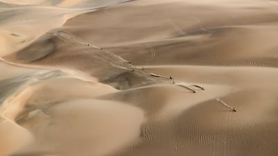 Competitors ride their motorbike across the dunes during stage nine of the Dakar Rally in Pisco, Peru. AP Photo