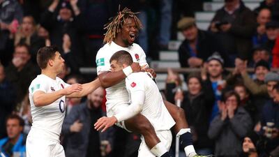 England wing Jonny May, centre, celebrates after scoring the first try against South Africa. Adrian Dennis / AFP