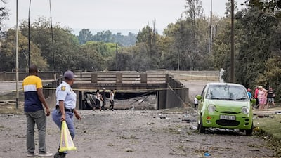 Residents and police officers examine the scene of the blast. EPA
