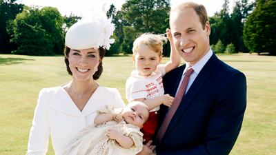 The Duke and Duchess of Cambridge and their children, Princess Charlotte and Prince George, pose together the day before Prince George's 2nd birthday.