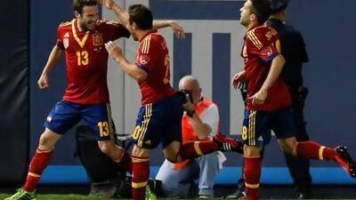 Spain’s Juan Mata, left, is congratulated by teammates after scoring in a 2-0 win over Ireland at Yankee Stadium in New York on Tuesday. Adrees Latif / Reuters
