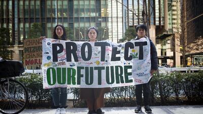 A group of climate activists display a protest banner. Bloomberg
