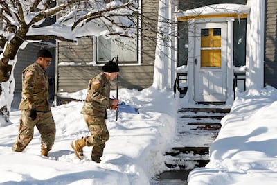 National Guard members check on residents in Buffalo, New York, following a winter storm. AP