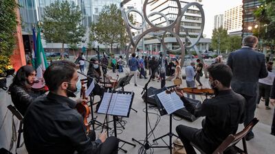 Musicians perform at the inauguration of a sculpture by Lebanese artist Nayla Romanos Iliya titled 'On the Other Side of Time', a permanent artwork erected in front of the church or St Elias, in Beirut, on October 20. AFP
