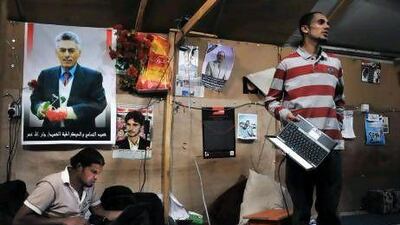 Hussein Moghram, left, and Osama Shamsan at work inside a tent that serves as a media centre in Change Square.