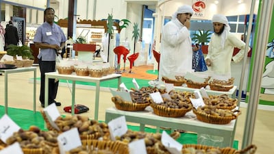 Spectators taste dates from the Date Index booth at the Emirates International Date Palm Festival. Andrew Henderson / The National
