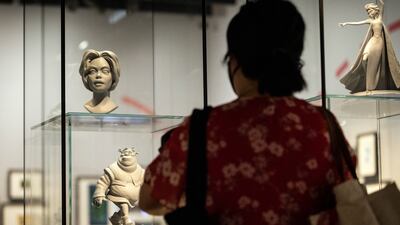 A visitor looks at figurines of Shrek used in preliminary researches for animated characters in animation movies. EPA