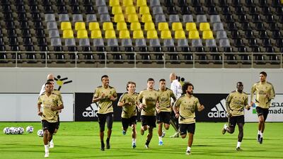 Players warm up during a training session. AFP