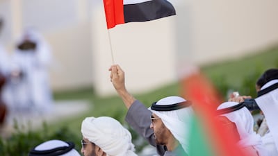 Sheikh Mohamed waves a UAE flag. Ryan Carter / Presidential Court