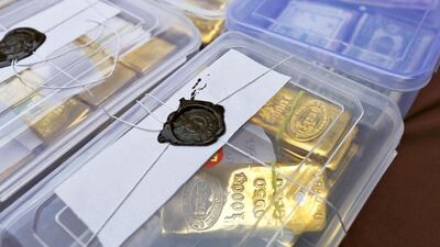 Above, seized gold bars are kept on display at a police station in Ahmedabad. Amit Dave / Reuters