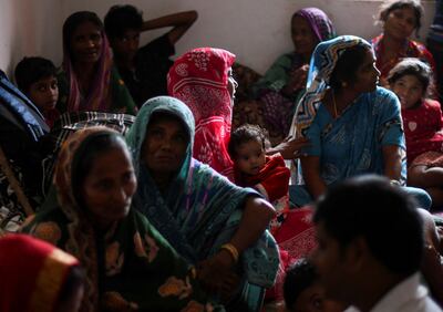 People evacuated from the village of Amarnagar sit inside a storm shelter on Thursday. Reuters