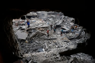 Palestinians inspect the site of a house hit by Israeli air strikes in Al Zawayda, central Gaza. Reuters