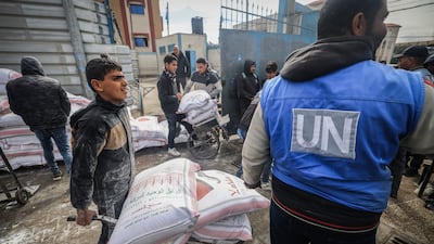 Displaced Palestinians receive food aid at a UNRWA centre in Rafah, southern Gaza. AFP
