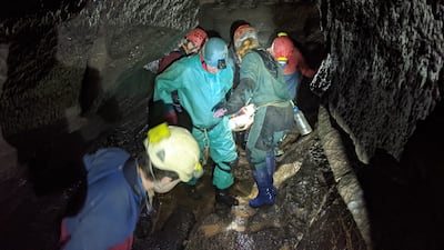 Members of a rescue team carrying an injured man on a stretcher out of a cave in the Brecon Beacons in Wales. PA.
