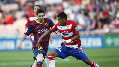 Barcelona's Lionel Messi, left, is challenged by Granada's Jeison Murillo during their Spanish Primera Liga match in Granada. Barcelona lost the match. Marcelo del Pozo / Reuters