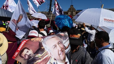 A supporter holds a poster featuring an image of Andres Manuel Lopez Obrador. Bloomberg