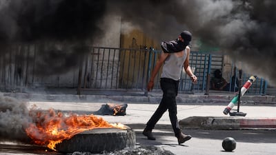 Tyres burn amid violence between Palestinian protesters and Israeli forces conducting a raid in Jenin, in the occupied West Bank. AFP