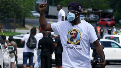A man raises his fist during the funeral procession. Reuters