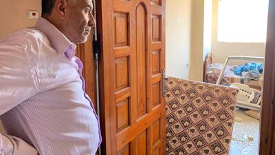 Abu Alkas looks at the damage to his home caused by Israeli airstrikes in Gaza. Nagham Mohanna for The National