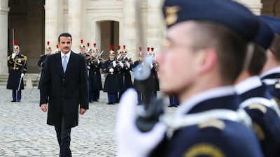 Sheikh Tamim inspects French troops in the courtyard of the Hotel des Invalides. AP