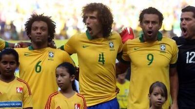 Before Wednesday’s match against Mexico, Brazil’s Marcelo, left, David Luiz, and Fred sing their country’s national anthem in Fortaleza. Scott Heavey / Getty Images