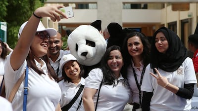 Participants take a selfie with a 'Panda' during the Great Green Race in Abu Dhabi. Ravindranath K / The National