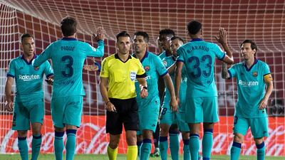Lionel Messi (R) celebrates with teammates after scoring against Mallorca. AFP