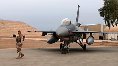 In this February 13, 2018 file photo, an Iraqi army soldier stands guard near a US-made Iraqi Air Force F-16 fighter jet at the Balad Air Base, Iraq. AP