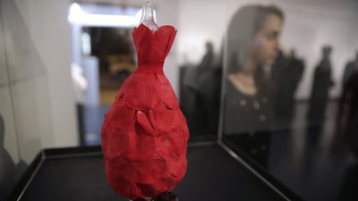 ‘La Rose Rouge’, a custom-designed miniature mannequin, by Dimah Shamma, 16, the youngest participating artist, stands on display.