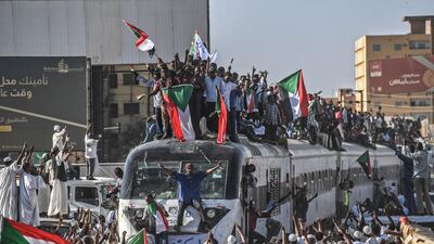 Thousands of protesters arrived in Khartoum by train on Tuesday to join a weeks-long sit-in. Ozan Kose / AFP