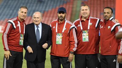 Member's of the UAE's backroom staff take a picture with Sepp Blatter.