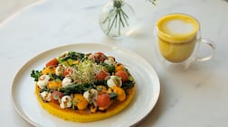 Chickpea omelette with crispy kale, tomato confit, mayo, carrot cream, balsamic glaze and roasted pumpkin seeds. Photo: Planet Terra