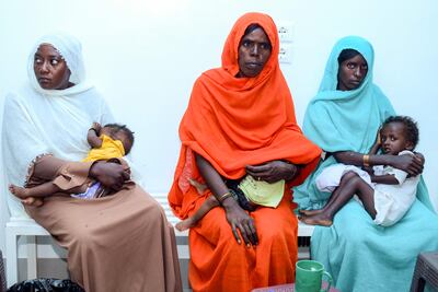 Mothers and toddlers wait at the Italian Paediatric Hospital in Port Sudan. Women and children in Sudan face the greatest barriers in accessing food, shelter and health care. AFP