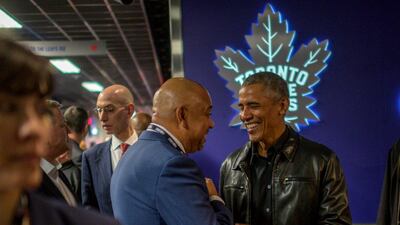 Former US president Barack Obama talks with ESPN sports commentator Michael Wilson. EPA
