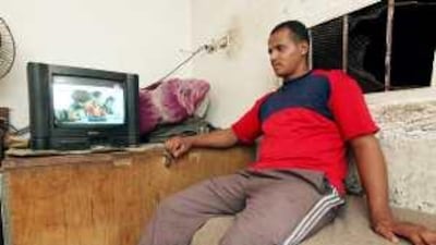 A boy and his his uncle watch a television commercial in between soap operas in Cairo.