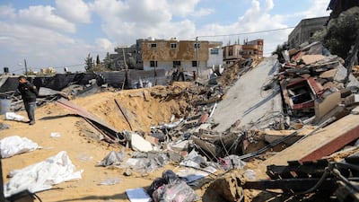 People inspect the damage to their homes after Israeli air strikes on Rafah. Getty