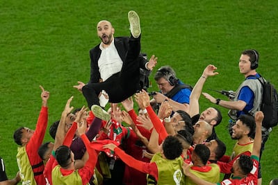 Morocco manager Walid Regragui is given the bumps by his players after the World Cup Round of 16 victory against Spain at the Education City Stadium in Al Rayyan, Qatar, on Tuesday, December 6, 2022. AP