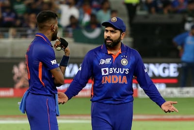 India's Rohit Sharma talks to Hardik Pandya. Reuters