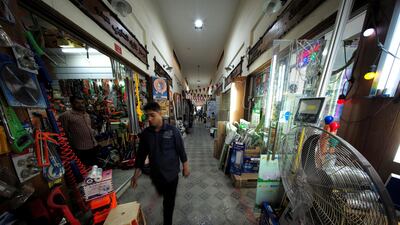 People are seen at shops, following the outbreak of Coronavirus disease (COVID-19), in Isa Town south of Manama, Bahrain, March 23, 2020. Reuters